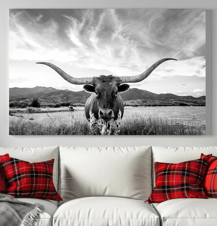 A modern living room showcases a black and white triptych of the "Longhorn Cow Wall Art Canvas Print Farmhouse Wall Art Texas longhorn wall art.