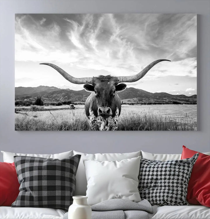 A modern living room showcases a black and white triptych of the "Longhorn Cow Wall Art Canvas Print Farmhouse Wall Art Texas longhorn wall art.