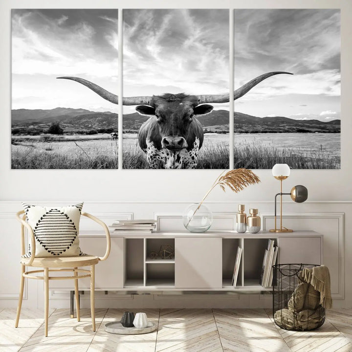 A modern living room showcases a black and white triptych of the "Longhorn Cow Wall Art Canvas Print Farmhouse Wall Art Texas longhorn wall art.