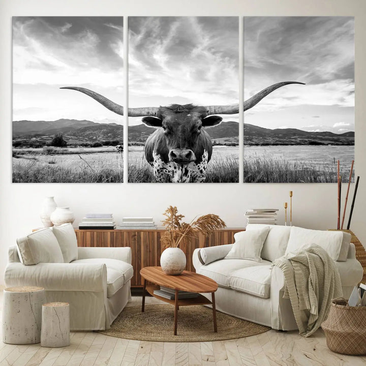 A modern living room showcases a black and white triptych of the "Longhorn Cow Wall Art Canvas Print Farmhouse Wall Art Texas longhorn wall art.