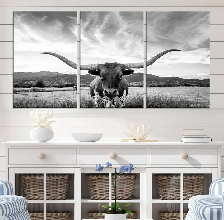 A modern living room showcases a black and white triptych of the "Longhorn Cow Wall Art Canvas Print Farmhouse Wall Art Texas longhorn wall art.