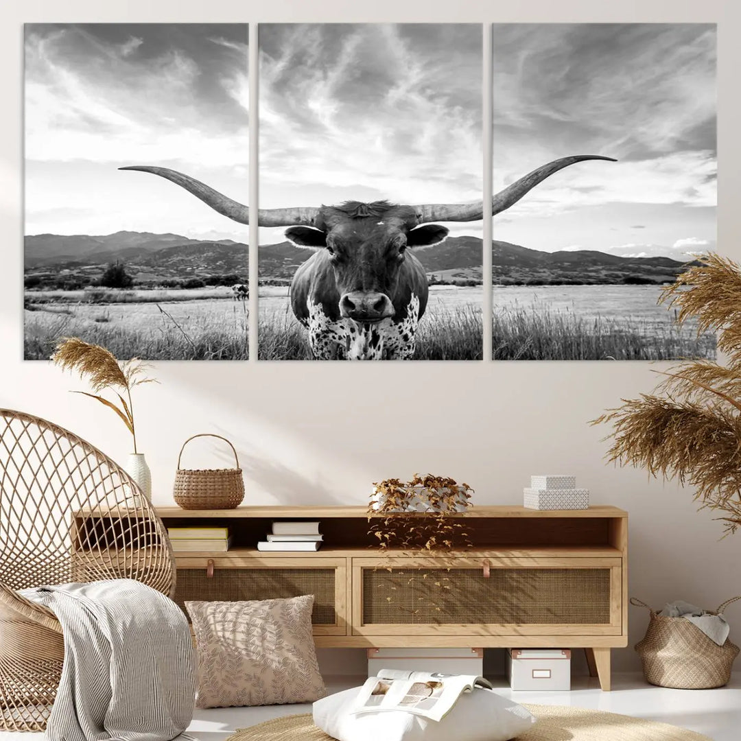 A modern living room showcases a black and white triptych of the "Longhorn Cow Wall Art Canvas Print Farmhouse Wall Art Texas longhorn wall art.