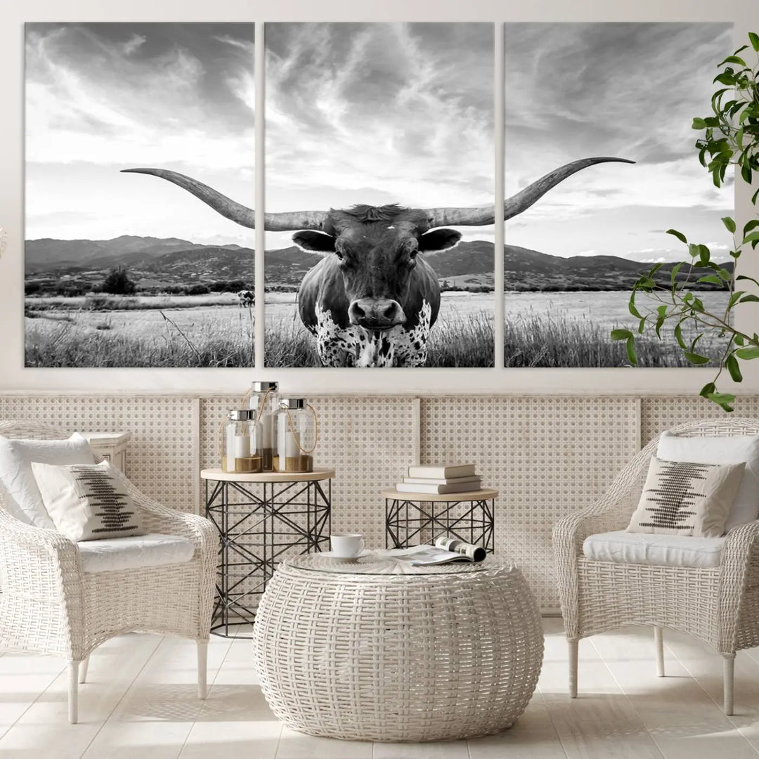 A modern living room showcases a black and white triptych of the "Longhorn Cow Wall Art Canvas Print Farmhouse Wall Art Texas longhorn wall art.