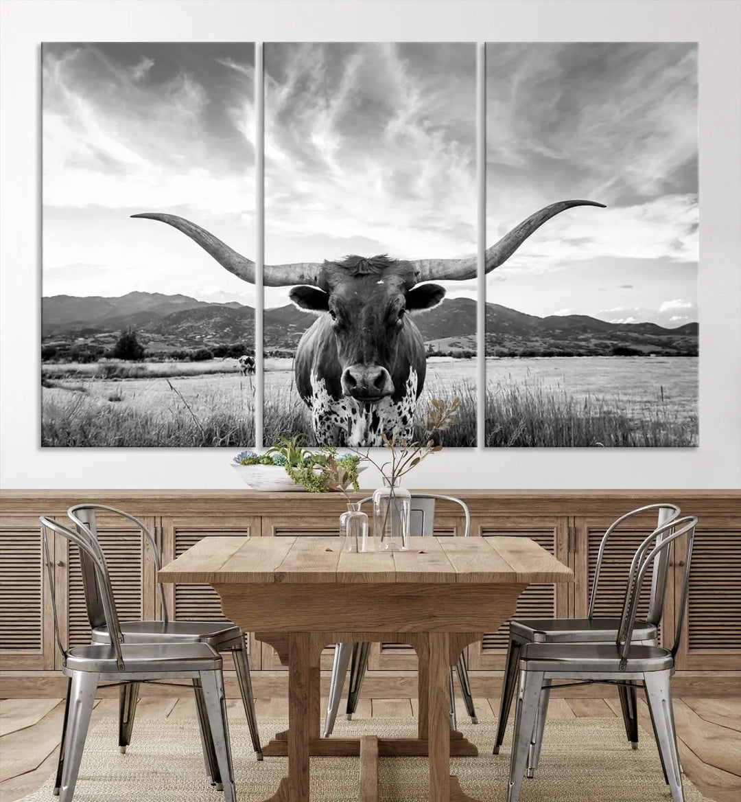 A modern living room showcases a black and white triptych of the "Longhorn Cow Wall Art Canvas Print Farmhouse Wall Art Texas longhorn wall art.