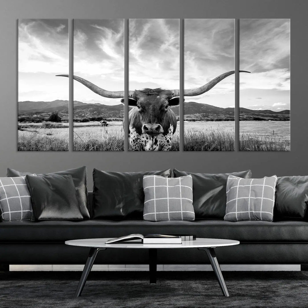 A modern living room showcases a black and white triptych of the "Longhorn Cow Wall Art Canvas Print Farmhouse Wall Art Texas longhorn wall art.