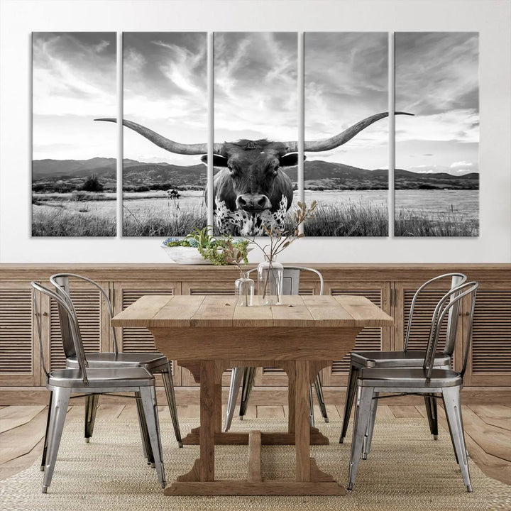 A modern living room showcases a black and white triptych of the "Longhorn Cow Wall Art Canvas Print Farmhouse Wall Art Texas longhorn wall art.