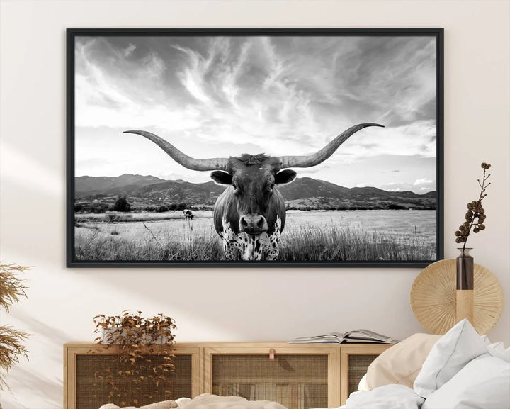 A modern living room showcases a black and white triptych of the "Longhorn Cow Wall Art Canvas Print Farmhouse Wall Art Texas longhorn wall art.