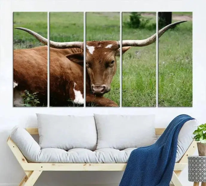 Longhorn steer triptych canvas wall art in a cozy living room setting.