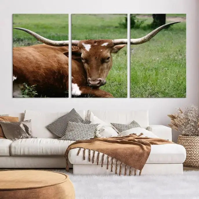 Longhorn steer triptych canvas wall art in a cozy living room setting.