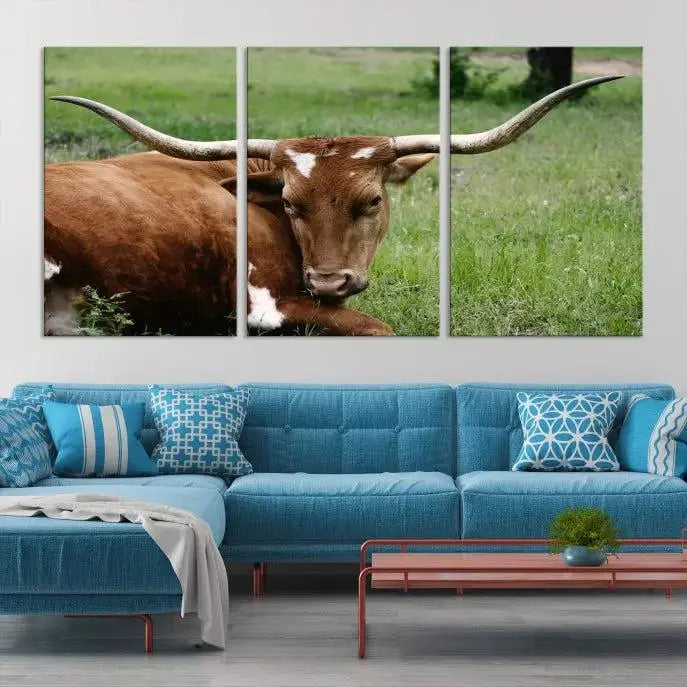 Longhorn steer triptych canvas wall art in a cozy living room setting.
