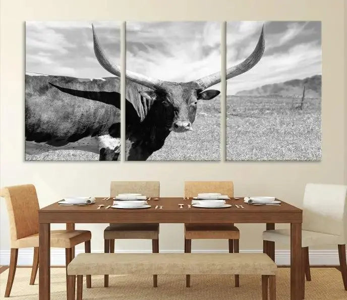 The Longhorn Wall Art Canvas Print, a black and white triptych of a longhorn cow in a grassy field, is elegantly displayed on museum-quality canvases.