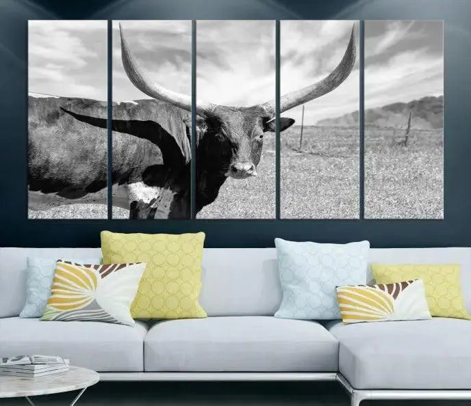 The Longhorn Wall Art Canvas Print, a black and white triptych of a longhorn cow in a grassy field, is elegantly displayed on museum-quality canvases.