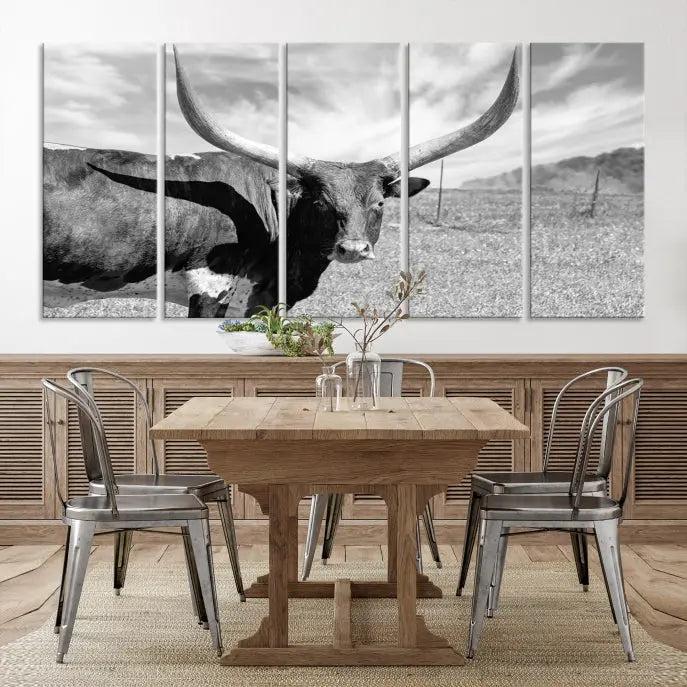 The Longhorn Wall Art Canvas Print, a black and white triptych of a longhorn cow in a grassy field, is elegantly displayed on museum-quality canvases.