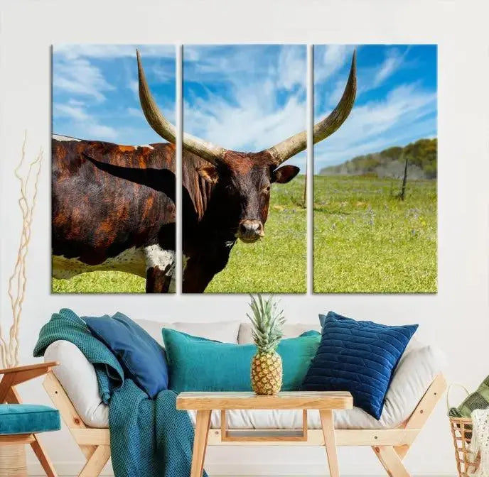 The Longhorn and Cow Wall Art Canvas Print features a triptych of a longhorn cow in a grassy field on a sunny day. These gallery-wrapped, museum-quality canvases are crafted by professional craftsmen to perfectly accentuate the scene, adding an exquisite touch to any living space.