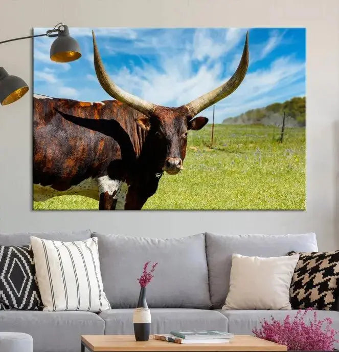 The Longhorn and Cow Wall Art Canvas Print features a triptych of a longhorn cow in a grassy field on a sunny day. These gallery-wrapped, museum-quality canvases are crafted by professional craftsmen to perfectly accentuate the scene, adding an exquisite touch to any living space.