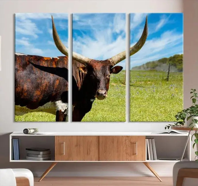 The Longhorn and Cow Wall Art Canvas Print features a triptych of a longhorn cow in a grassy field on a sunny day. These gallery-wrapped, museum-quality canvases are crafted by professional craftsmen to perfectly accentuate the scene, adding an exquisite touch to any living space.