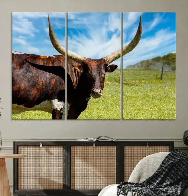 The Longhorn and Cow Wall Art Canvas Print features a triptych of a longhorn cow in a grassy field on a sunny day. These gallery-wrapped, museum-quality canvases are crafted by professional craftsmen to perfectly accentuate the scene, adding an exquisite touch to any living space.