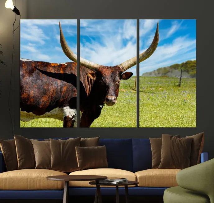 The Longhorn and Cow Wall Art Canvas Print features a triptych of a longhorn cow in a grassy field on a sunny day. These gallery-wrapped, museum-quality canvases are crafted by professional craftsmen to perfectly accentuate the scene, adding an exquisite touch to any living space.