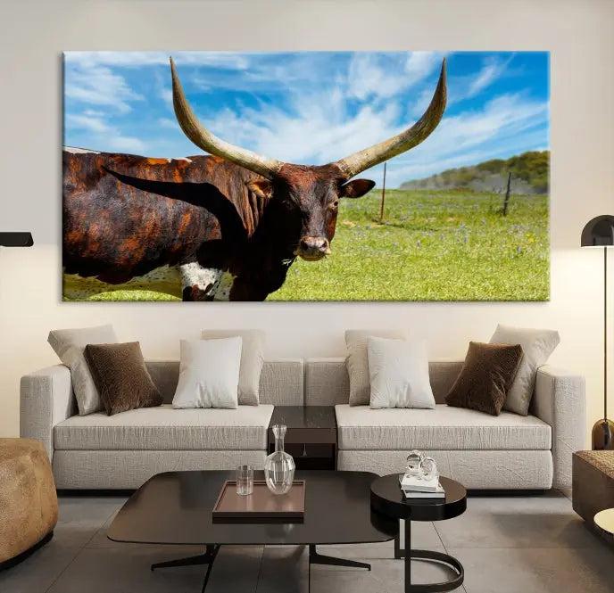 The Longhorn and Cow Wall Art Canvas Print features a triptych of a longhorn cow in a grassy field on a sunny day. These gallery-wrapped, museum-quality canvases are crafted by professional craftsmen to perfectly accentuate the scene, adding an exquisite touch to any living space.