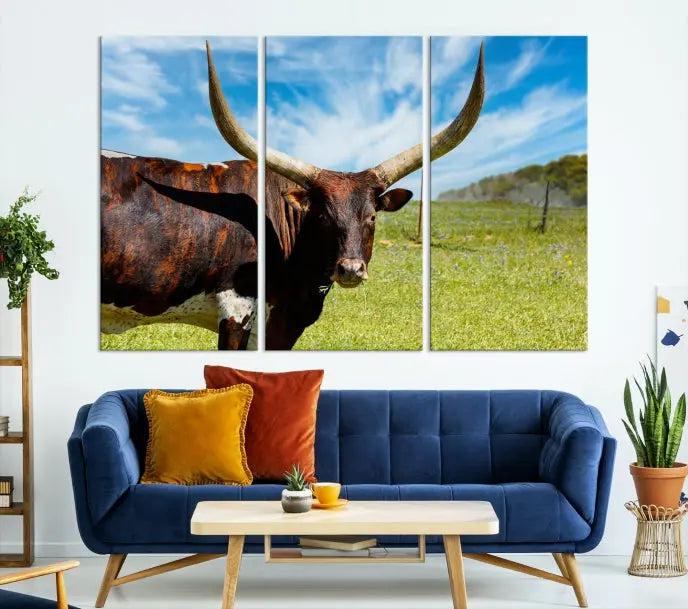 The Longhorn and Cow Wall Art Canvas Print features a triptych of a longhorn cow in a grassy field on a sunny day. These gallery-wrapped, museum-quality canvases are crafted by professional craftsmen to perfectly accentuate the scene, adding an exquisite touch to any living space.