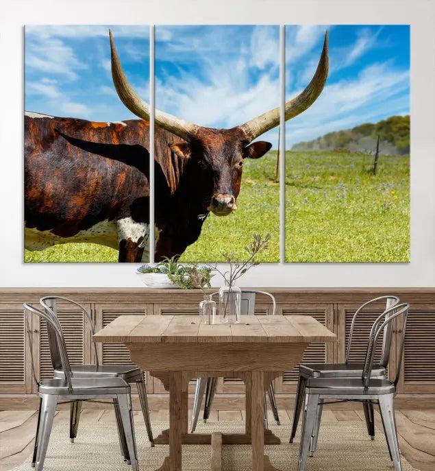 The Longhorn and Cow Wall Art Canvas Print features a triptych of a longhorn cow in a grassy field on a sunny day. These gallery-wrapped, museum-quality canvases are crafted by professional craftsmen to perfectly accentuate the scene, adding an exquisite touch to any living space.