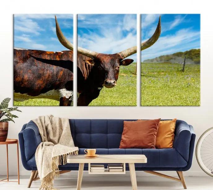 The Longhorn and Cow Wall Art Canvas Print features a triptych of a longhorn cow in a grassy field on a sunny day. These gallery-wrapped, museum-quality canvases are crafted by professional craftsmen to perfectly accentuate the scene, adding an exquisite touch to any living space.