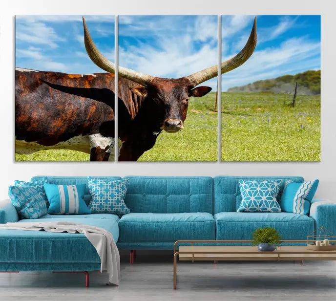 The Longhorn and Cow Wall Art Canvas Print features a triptych of a longhorn cow in a grassy field on a sunny day. These gallery-wrapped, museum-quality canvases are crafted by professional craftsmen to perfectly accentuate the scene, adding an exquisite touch to any living space.