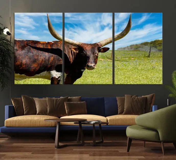 The Longhorn and Cow Wall Art Canvas Print features a triptych of a longhorn cow in a grassy field on a sunny day. These gallery-wrapped, museum-quality canvases are crafted by professional craftsmen to perfectly accentuate the scene, adding an exquisite touch to any living space.