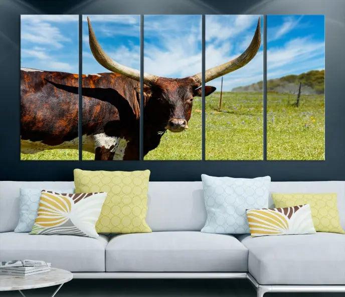 The Longhorn and Cow Wall Art Canvas Print features a triptych of a longhorn cow in a grassy field on a sunny day. These gallery-wrapped, museum-quality canvases are crafted by professional craftsmen to perfectly accentuate the scene, adding an exquisite touch to any living space.