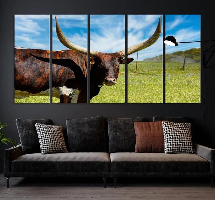 The Longhorn and Cow Wall Art Canvas Print features a triptych of a longhorn cow in a grassy field on a sunny day. These gallery-wrapped, museum-quality canvases are crafted by professional craftsmen to perfectly accentuate the scene, adding an exquisite touch to any living space.