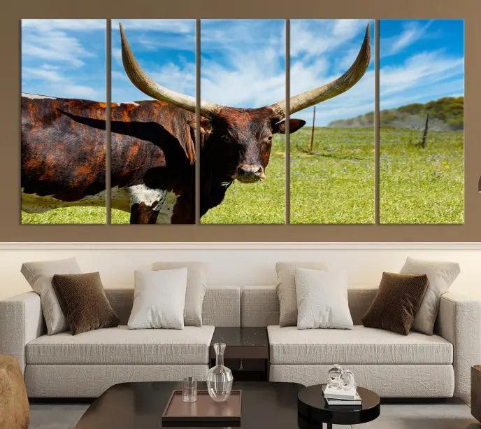 The Longhorn and Cow Wall Art Canvas Print features a triptych of a longhorn cow in a grassy field on a sunny day. These gallery-wrapped, museum-quality canvases are crafted by professional craftsmen to perfectly accentuate the scene, adding an exquisite touch to any living space.