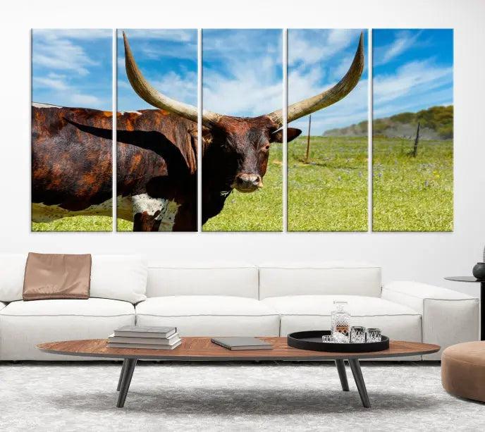 The Longhorn and Cow Wall Art Canvas Print features a triptych of a longhorn cow in a grassy field on a sunny day. These gallery-wrapped, museum-quality canvases are crafted by professional craftsmen to perfectly accentuate the scene, adding an exquisite touch to any living space.