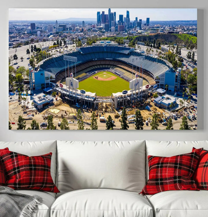 Aerial view of Dodger Stadium, home to the Los Angeles Dodgers, set against a city skyline and featured as a striking wall art piece across three framed panels, offering a gallery-quality finish.