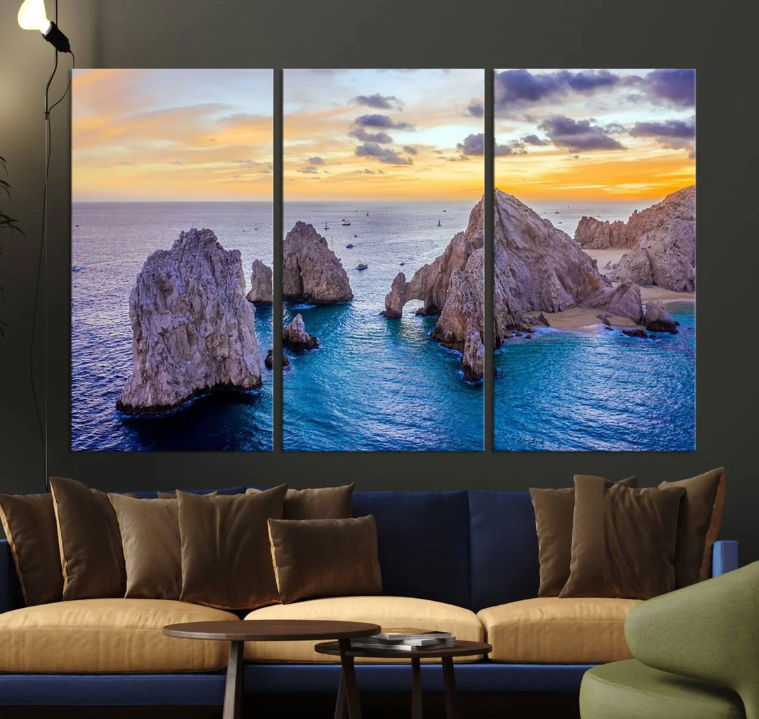 The living room features the Los Cabos San Lucas Ocean Canvas Wall Art Print, showcasing Mexico's Cabo Arch. Made from museum-quality canvases with UV-protective coating, this triptych wall art depicts a coastal scene at sunset and arrives ready to hang for effortless elegance.