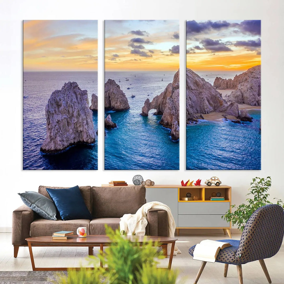 The living room features the Los Cabos San Lucas Ocean Canvas Wall Art Print, showcasing Mexico's Cabo Arch. Made from museum-quality canvases with UV-protective coating, this triptych wall art depicts a coastal scene at sunset and arrives ready to hang for effortless elegance.