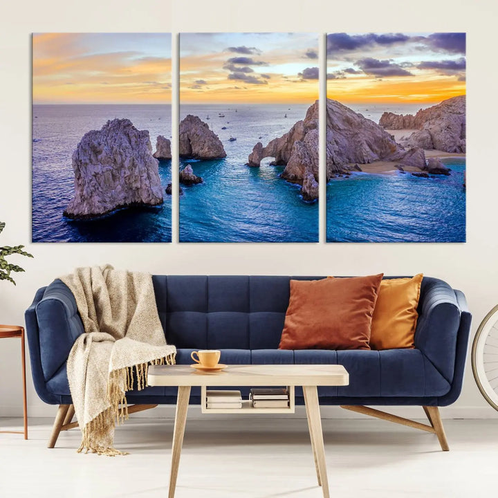 The living room features the Los Cabos San Lucas Ocean Canvas Wall Art Print, showcasing Mexico's Cabo Arch. Made from museum-quality canvases with UV-protective coating, this triptych wall art depicts a coastal scene at sunset and arrives ready to hang for effortless elegance.