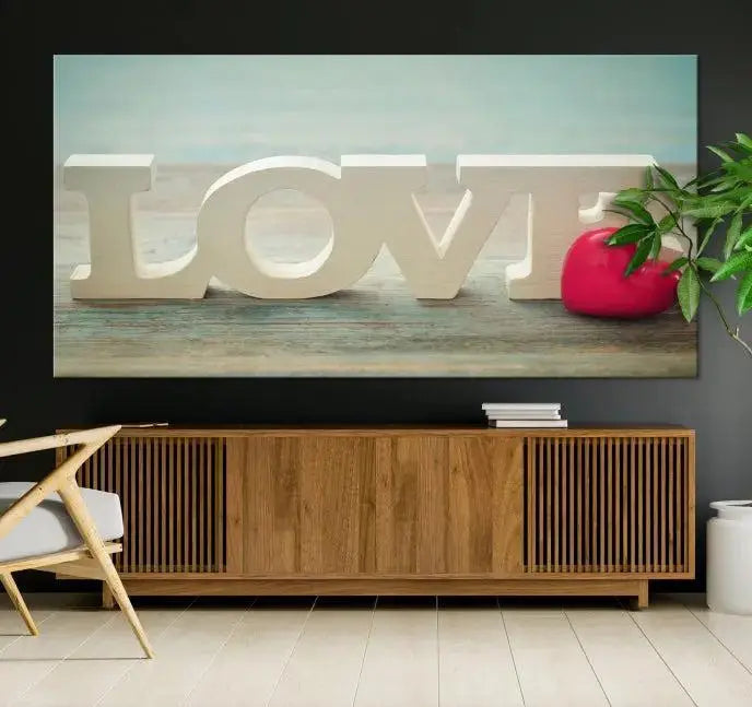 The Love Wall Art Canvas Print features the word "LOVE" in white block letters next to a vibrant red heart, enhanced with a UV-protective coating for durability. This piece adds enduring elegance and is crafted from museum-quality canvas, available with free shipping.