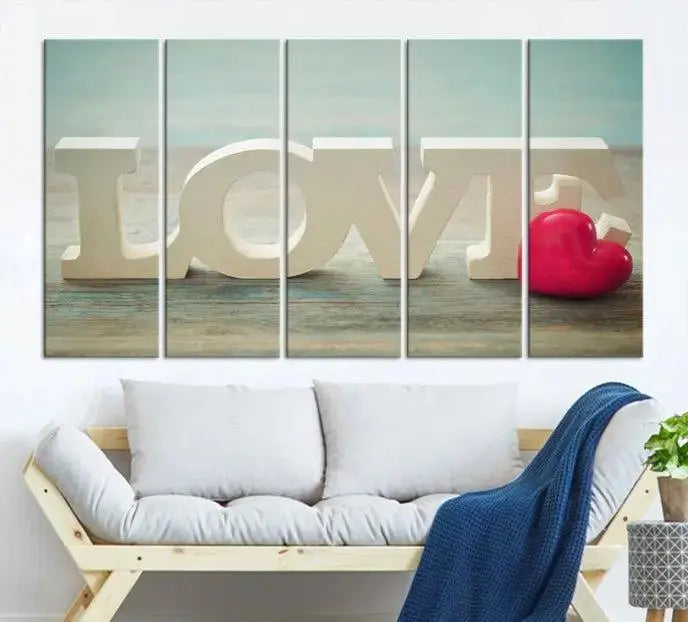 The Love Wall Art Canvas Print features the word "LOVE" in white block letters next to a vibrant red heart, enhanced with a UV-protective coating for durability. This piece adds enduring elegance and is crafted from museum-quality canvas, available with free shipping.