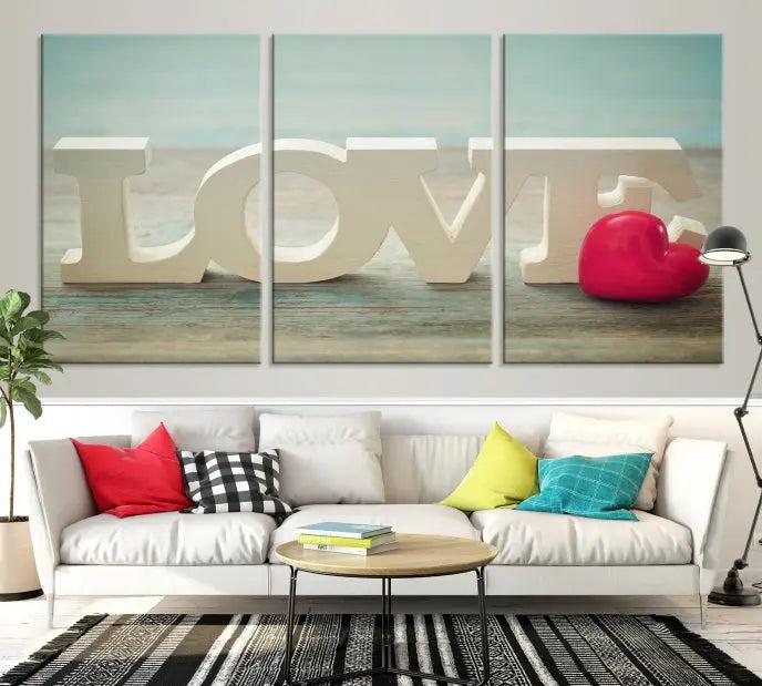 The Love Wall Art Canvas Print features the word "LOVE" in white block letters next to a vibrant red heart, enhanced with a UV-protective coating for durability. This piece adds enduring elegance and is crafted from museum-quality canvas, available with free shipping.