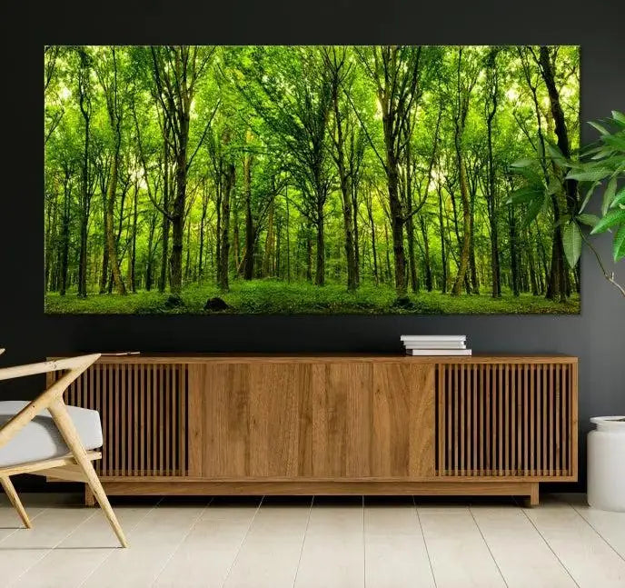 A modern living room features the Lush Green Forest Canvas Print—a 3-panel forest wall art—mounted above, creating an ideal retreat for nature lovers.