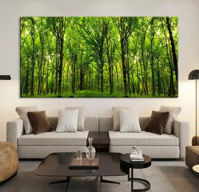 A modern living room features the Lush Green Forest Canvas Print—a 3-panel forest wall art—mounted above, creating an ideal retreat for nature lovers.