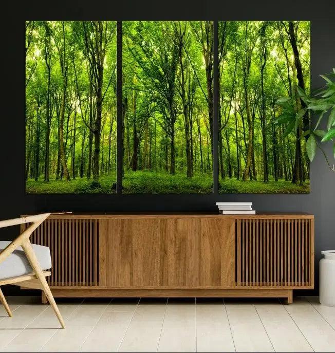 A modern living room features the Lush Green Forest Canvas Print—a 3-panel forest wall art—mounted above, creating an ideal retreat for nature lovers.