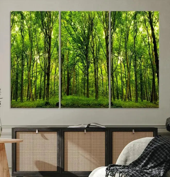 A modern living room features the Lush Green Forest Canvas Print—a 3-panel forest wall art—mounted above, creating an ideal retreat for nature lovers.