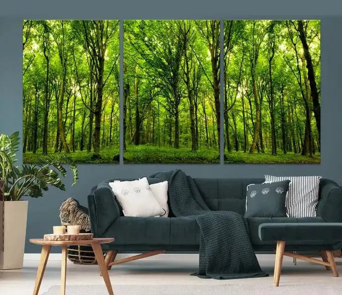 A modern living room features the Lush Green Forest Canvas Print—a 3-panel forest wall art—mounted above, creating an ideal retreat for nature lovers.