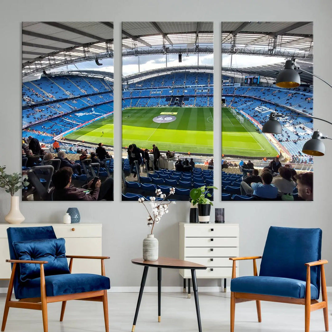 A captivating Manchester City Etihad Stadium Wall Art Canvas Print graces the living room, showcasing a football stadium with an empty field in a gallery-quality finish.