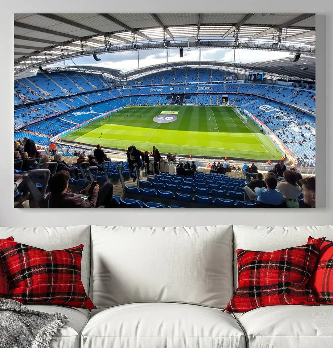 A captivating Manchester City Etihad Stadium Wall Art Canvas Print graces the living room, showcasing a football stadium with an empty field in a gallery-quality finish.