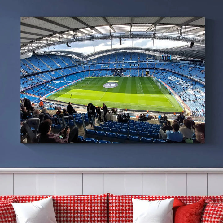 A captivating Manchester City Etihad Stadium Wall Art Canvas Print graces the living room, showcasing a football stadium with an empty field in a gallery-quality finish.