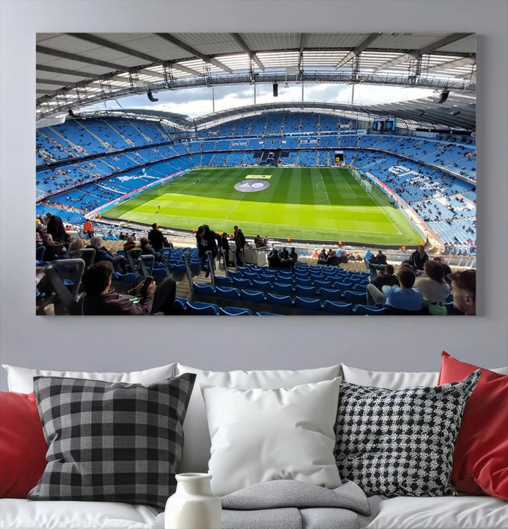 A captivating Manchester City Etihad Stadium Wall Art Canvas Print graces the living room, showcasing a football stadium with an empty field in a gallery-quality finish.