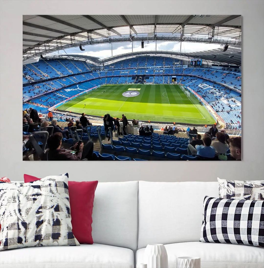 A captivating Manchester City Etihad Stadium Wall Art Canvas Print graces the living room, showcasing a football stadium with an empty field in a gallery-quality finish.