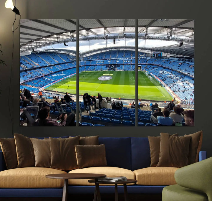 A captivating Manchester City Etihad Stadium Wall Art Canvas Print graces the living room, showcasing a football stadium with an empty field in a gallery-quality finish.